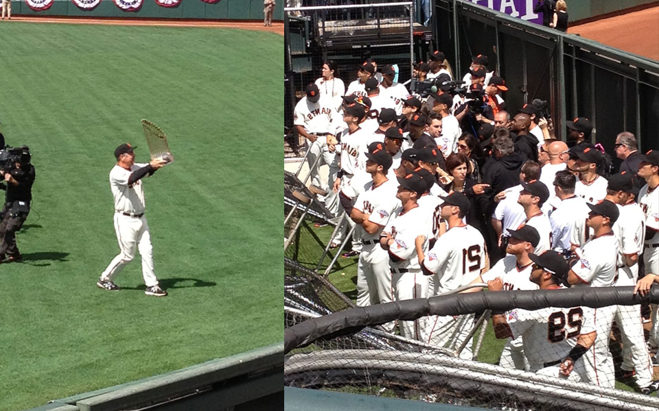 Bochy shows the crowd the World Series trophy
