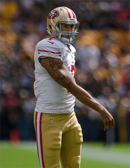 Tattooed quarterback Colin Kaepernick is the latest NFL player to be connected with criminal activity ( photo: Mike Morbeck)