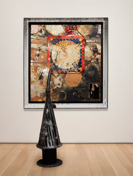 Bruce Conner, Tick-Tock Jelly Clock Cosmotron, 1961; wall component: wood, fabric, cardboard, wallpaper, magazine pages, stickers, string, twine, plastic film, glass fragments, mirror fragments, iron straps, grommets, nails, screws, upholstery tacks, metal foil, aluminum sheet, electrical socket, electrical wiring, rubber hose, beads, costume jewelry parts, sequins, ribbon, nylon stocking, cigarette filter, paint, graphite, bitumen, and resin on pressed hardboard; painted wood frame with mirror segments; floor component: wood spool, fiberboard cone, paper, paint, monofilament netting, electrical plug, insulated wire, speaker, audio cable, iron wire, rings and clips, paper, yarn, and twine; 5” reel of half-track monaural tape transferred to digital files; wall component: 57-1/2 × 53-3/4 × 5 in.; cone: 43-3/4 × 15 in. diameter (111.1 x 38.1 cm diameter); Art Institute of Chicago, restricted gift of Janss Foundation, Twentieth-Century Purchase Fund; © 2016 Conner Family Trust, San Francisco / Artists Rights Society (ARS), New York