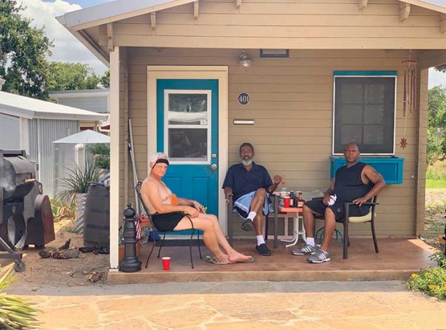 Clockwise from left: The street signs at Community First Village are all about the positive; Tiny Town neighbors relax while testing their ribs recipe for a community barbecue competition Photo: Susan Dyer Reynolds