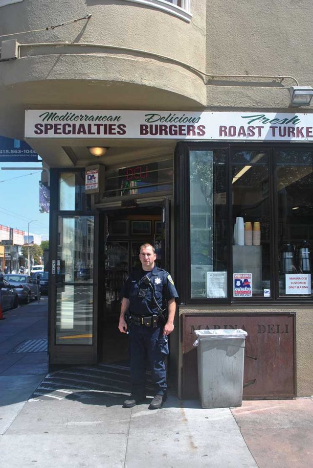 Officer Niko Hawes takes a lunch break at the Marina Deli, a popular spot for police offers working the Marina beat. He says there aren’t as many emergency calls during the quarantine, but people are calling for weirder reasons.